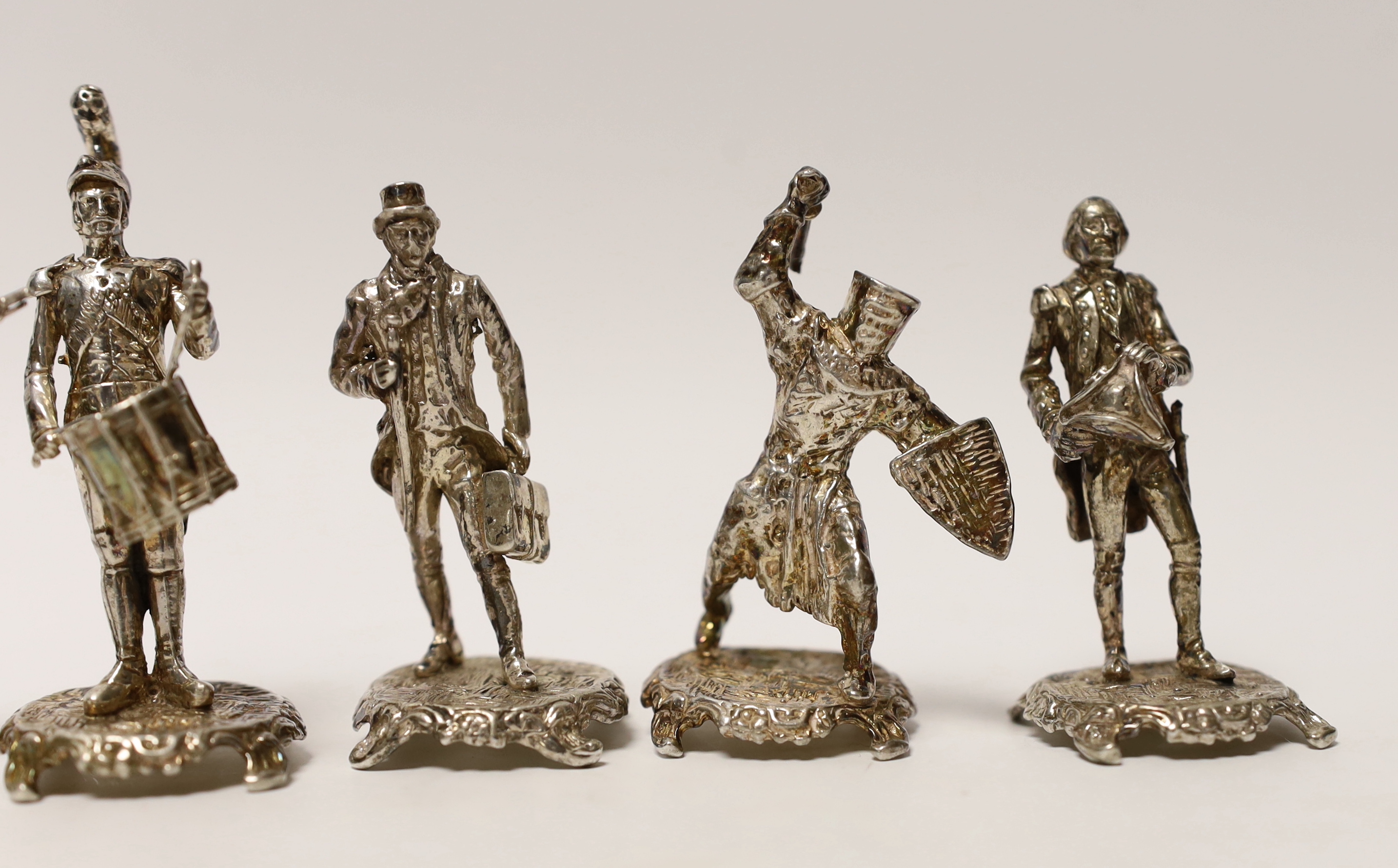 A set of five miniature silver model soldiers, maker SMC, London, 1975, tallest 75mm, together with a silver miniature model of an awl, same date and maker.